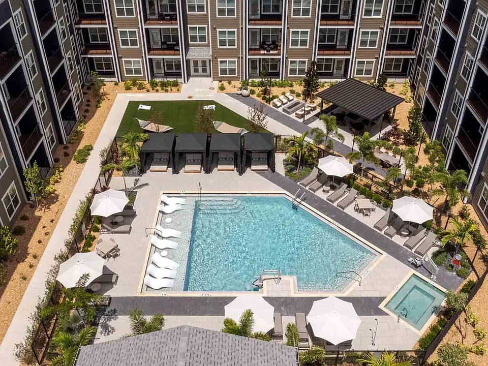 The courtyard pool includes a sun shelf with in-water loungers, a separate spa, and four private cabanas.