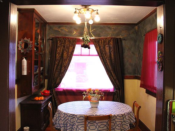 Nestled just off the kitchen, the dining room blends cozy warmth with thoughtful design_a welcoming spot for meals and meaningful conversation