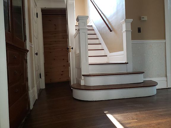 Staircase and coat closet off of foyer