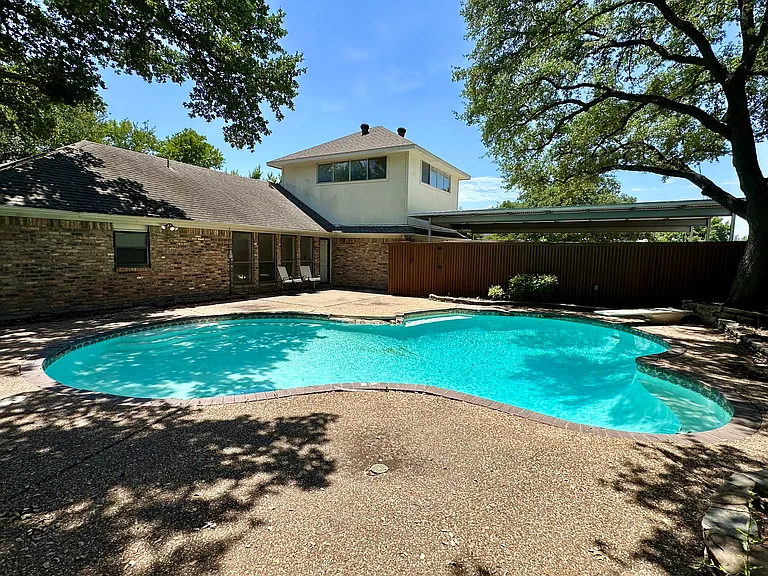 View of pool and patio with a fenced in backyard