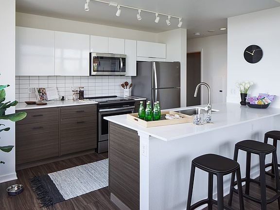 Large kitchen with island and stainless steel appliances