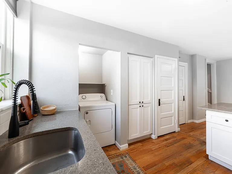 Washer and dryer, basement access, and coat closet (and stairs at the right)