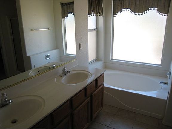 Master bath with dual vanity and soaking tub.