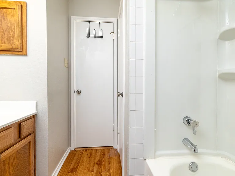 Upstairs Bathroom 2 includes a tub/shower combo, cabinet sink with mirror, and is stocked with soap, shampoo, and conditioner for your stay.