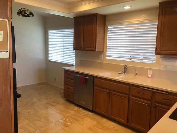 Kitchen has a beautiful stone counter-top and five-burner gas stove