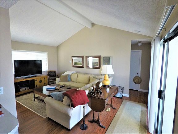 Living room viewed from dining room. Entrance to bedroom shown on right.