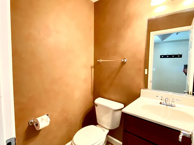 Half bathroom on first floor near entrance.