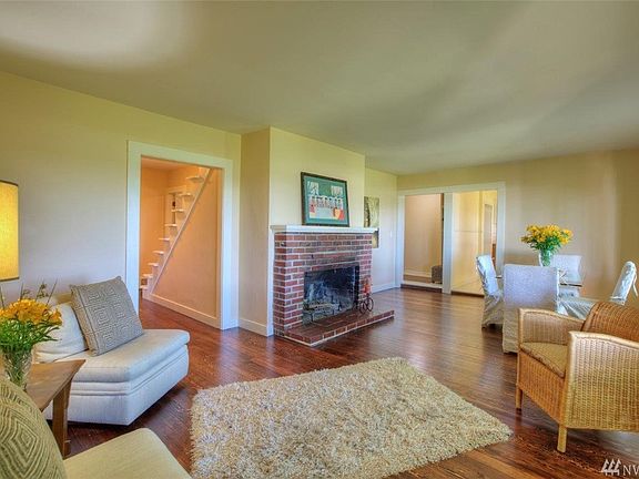 The Living/Dining space has a wood burning fireplace and is adjacent to the access to front hallways, kitchen and bedrooms