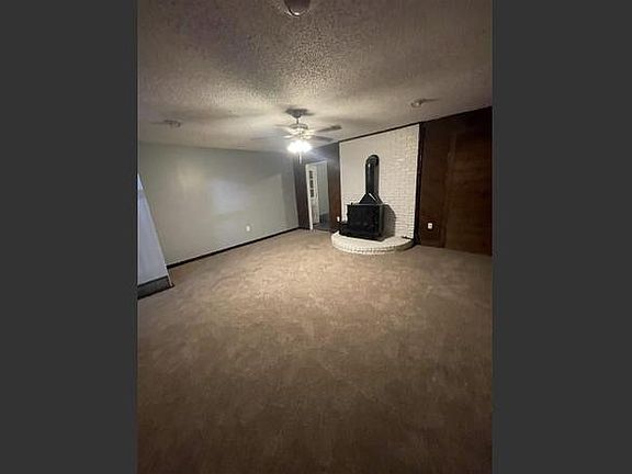 Carpeted Den with access to laundry room and garage.