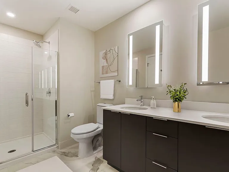 Renovated Package I bath with white quartz countertops, grey cabinetry, and hard surface flooring