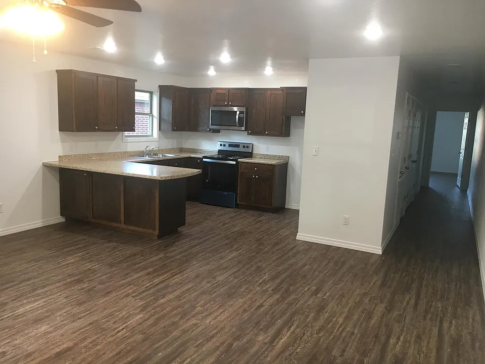 open kitchen area to living room & will have refrigerator