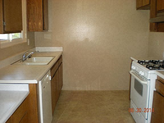 Kitchen w/ natural oak cabinets, gas oven & range, DW. Brand new custom quartz countertops being installed at end of March 2020.