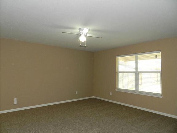 Large family room has windows overlooking the backyard.