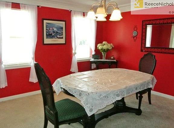 Dining Room with crown molding and vibrant decorator colors.