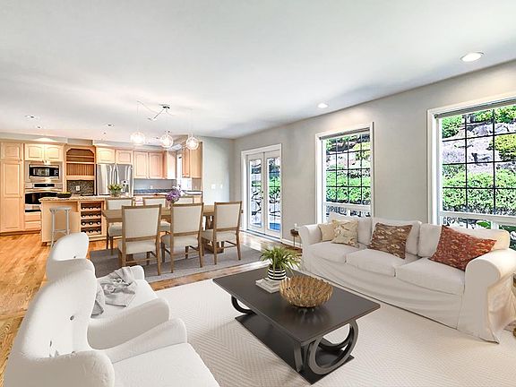 Open concept family room and kitchen. Huge wonderful windows. French doors lead to outdoor patio area.