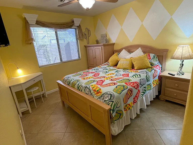 3rd bedroom with desk and ceilng fan armoire and TV!
