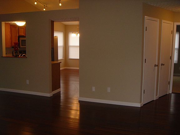 Open floor plan great room leading to kitchen and hallway leads to bedrooms