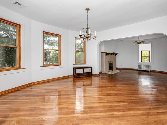 This elegant formal dining room seamlessly connects to the living room and is bathed in natural light, making it an ideal space for both everyday meals and special gatherings.