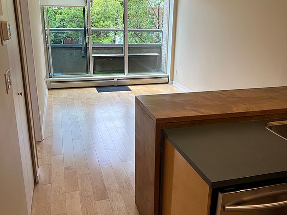 View from the kitchen to the lounge and out onto the balcony.