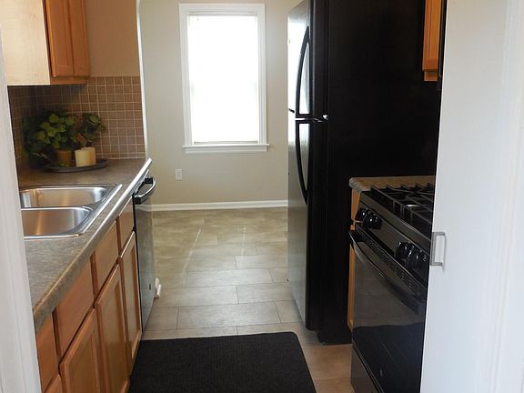 View into kitchen and dining area from side entry