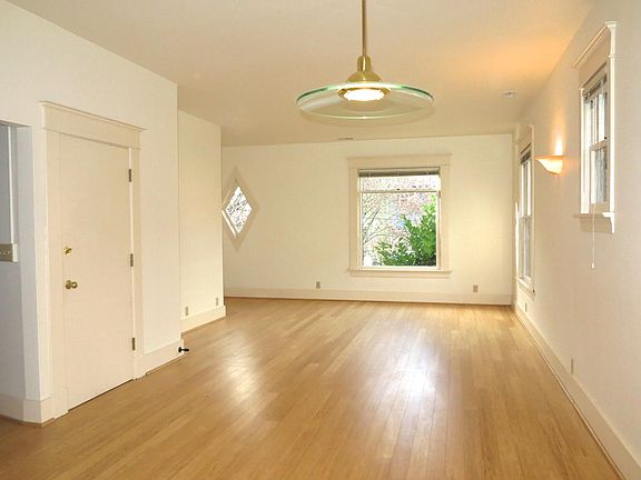 Open and roomy living & dining area. Great for entertaining. Lots of natural light . Lighting fixtures from Portland Own Rejuvenation Hardware through out.