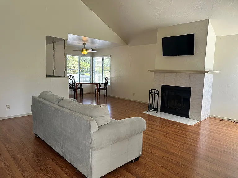 Living room with fireplace and dining area