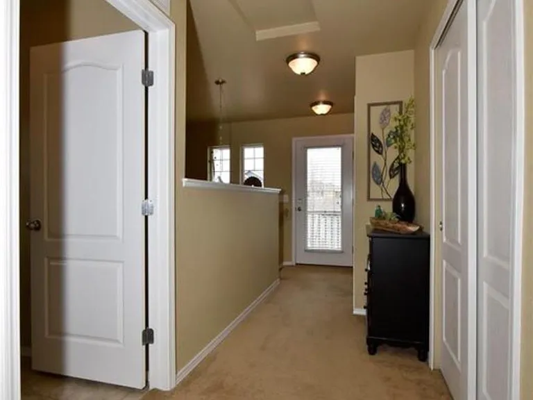 Upstairs hallway leading to covered porch and laundry room o