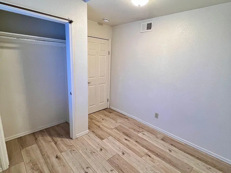 Bedroom 1 with view of closet and loft above