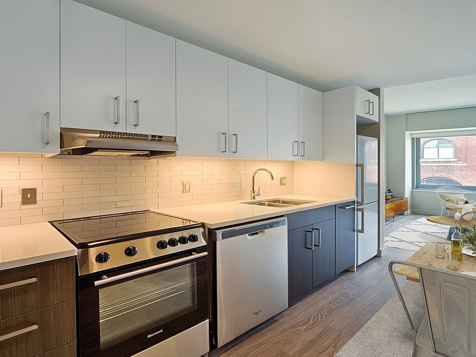 Open kitchens feature stainless steel appliances and quartz countertops