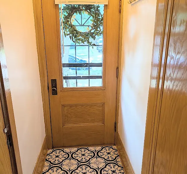 Front entryway "mud space" with new flooring and coat rack wall hooks