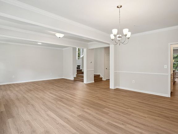 The dining room and living room of the Kendrick on homesite 3032 at Swan Point.