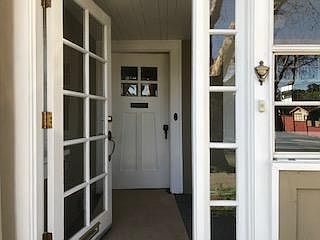 Entrance to enclosed porch and front door.