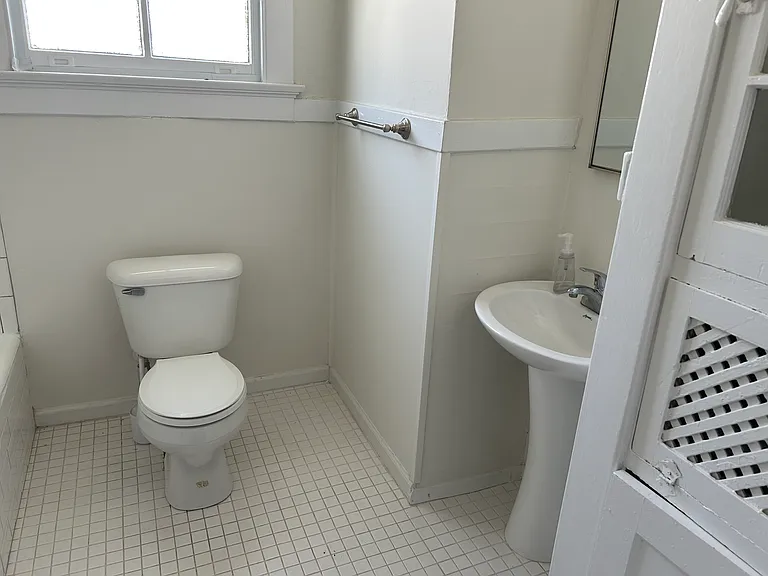 Bathroom off hallway- has refinished tub