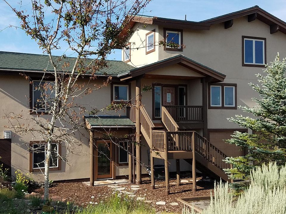 Front facade. Apartment entry is on bottom floor with parking in front of stairs or in garage.