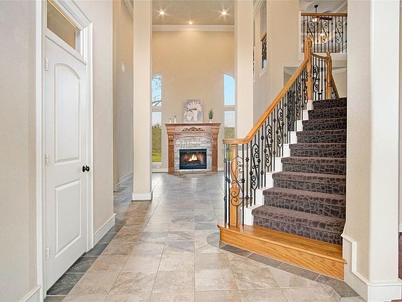 Beautiful entry with view of 1 of 2 of the staircases and a view of the family room.