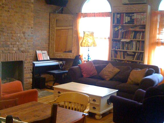 Very large living room (this pic with furniture) exposed brick wall and working gas fireplace hardwood floors and high ceilings, lots of light.