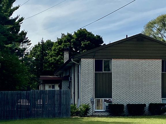 Exterior with fenced backyard.
