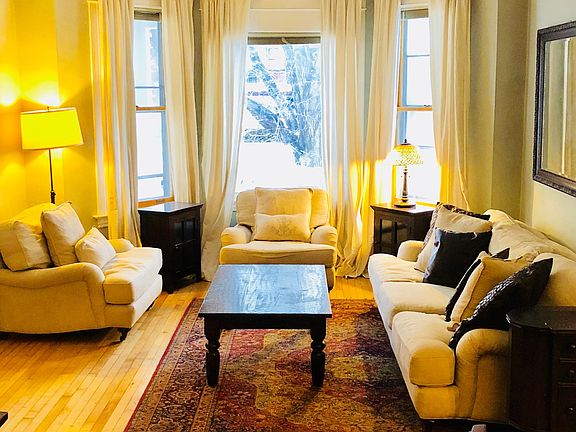 Large and bright formal living with bay windows facing porch