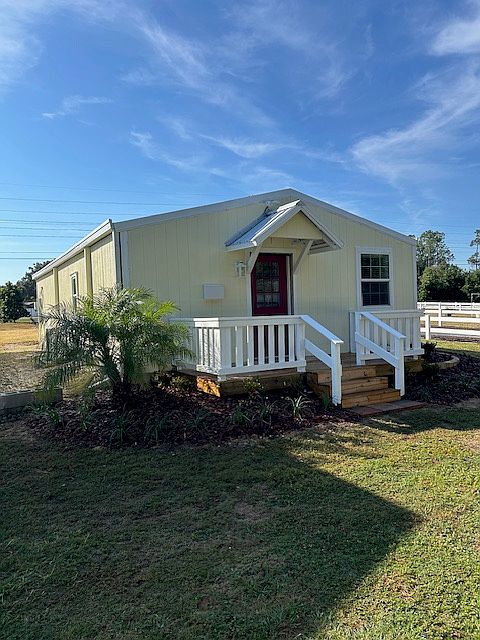 Front of cottage surrounded by Avocado grove