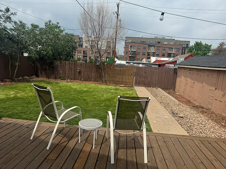 Patio and Grassy Backyard. Exterior storage shed in the backyard.