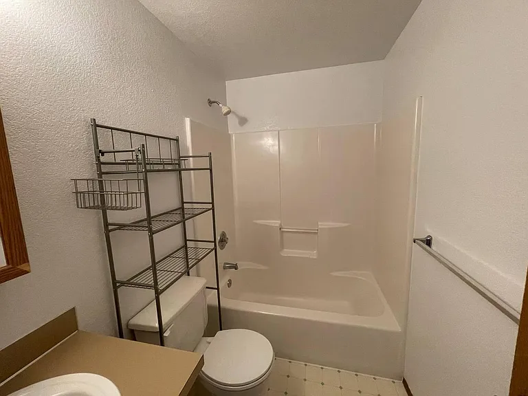 Full bathroom with tub/shower combination. Bathroom has been updated since these photos were taken.