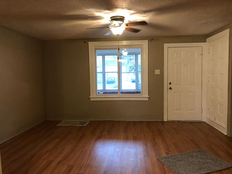 Living Room with lighted ceiling fan and coat closet