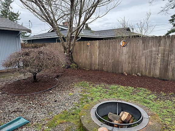 Backyard includes a flowering cherry tree and two dwarf Japanese maples (one seen here). A built in fire pit makes summer gatherings fun.