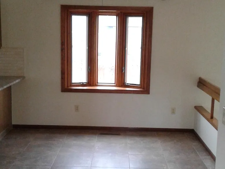 Dining area with family room and living room in view. Beautiful Anderson wood windows throughout.