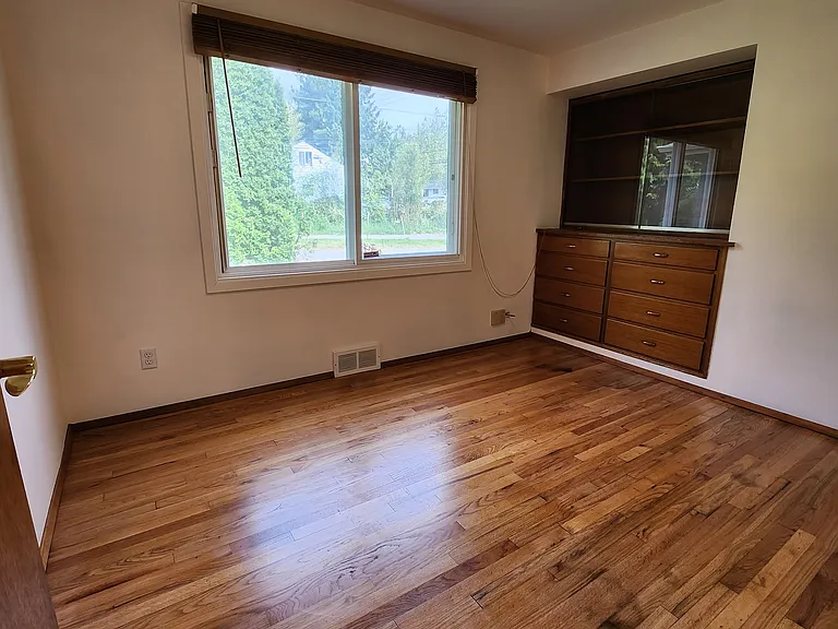 Bedroom 3: Towards the front of the house, facing front yard and entry wall. Would make a great office/guest room/work/hobby space with the built-in.