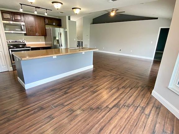 Large family/kitchen/dining combo view #2