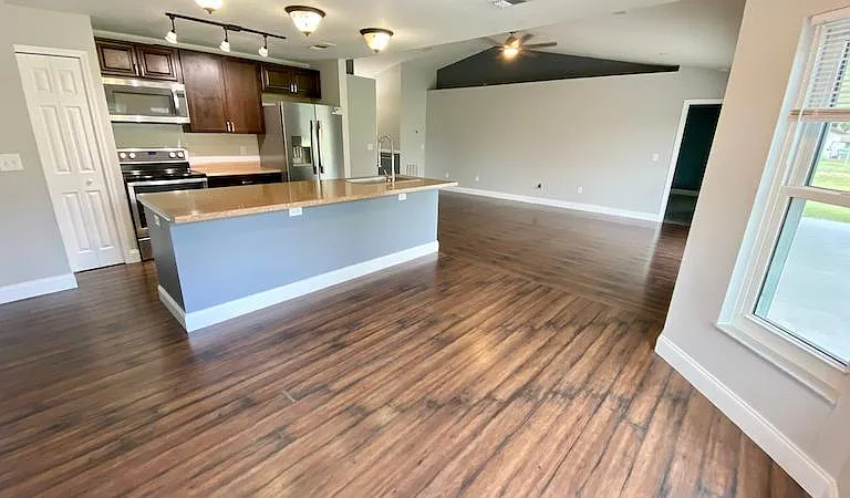 Large family/kitchen/dining combo view #2