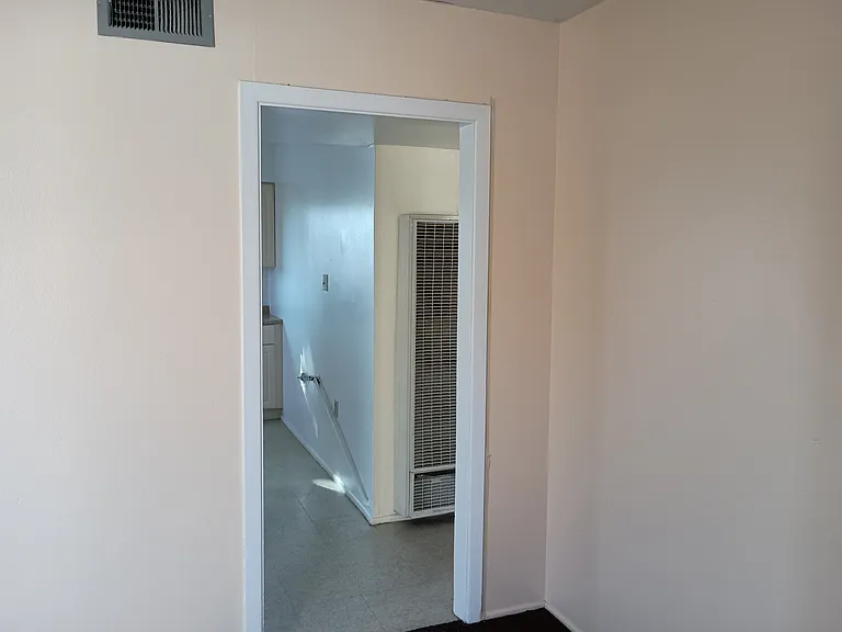 Kitchen and hallway access.