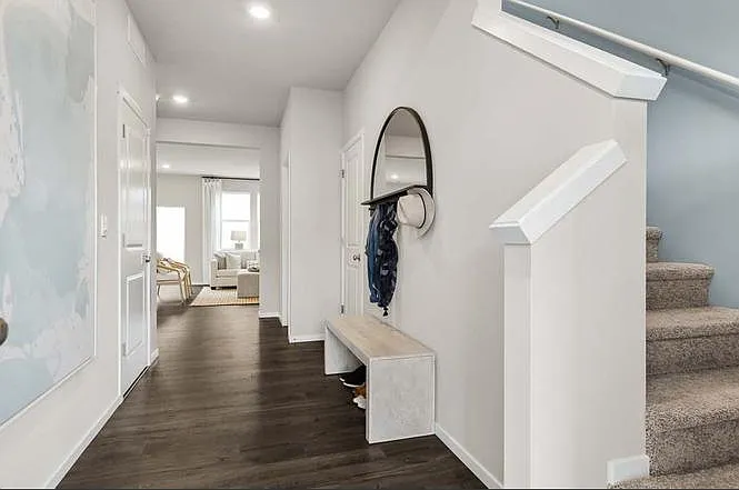 Foyer area with garage entrance, and two walk-in closets on both sides