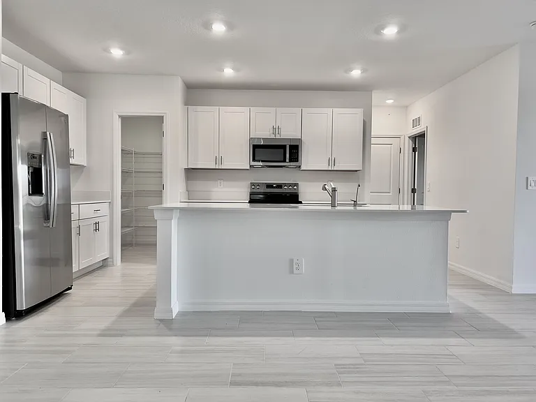 Open layout. Kitchen with Stainless Appliances